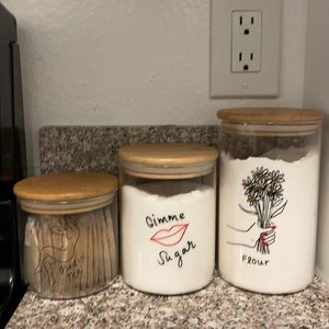 three containers for tea, sugar, and flower